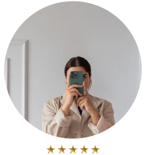 Person in a beige jacket, looking confident as they take a selfie in a mirror, holds their smartphone with both hands—perhaps capturing the essence of small business consulting success.